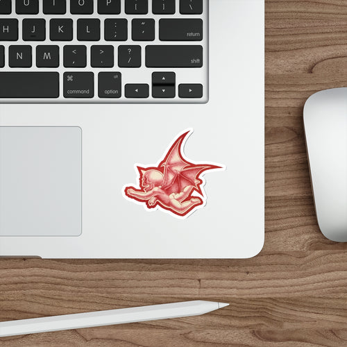A mock up of my original design Aourim © as a sticker in Red monochrome with a white boarder of a winged creature with a skull on a white background on a mock up computer
